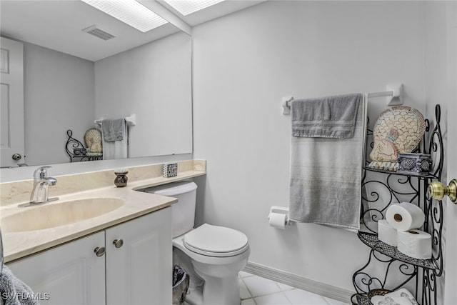 bathroom featuring tile patterned flooring, vanity, and toilet