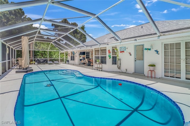 view of swimming pool with a lanai and a patio