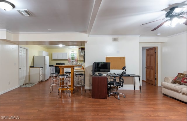 office area featuring hardwood / wood-style floors, ceiling fan, and crown molding