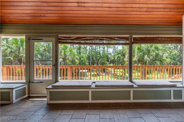 unfurnished sunroom featuring wood ceiling