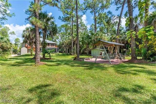 view of yard featuring an outbuilding and a playground