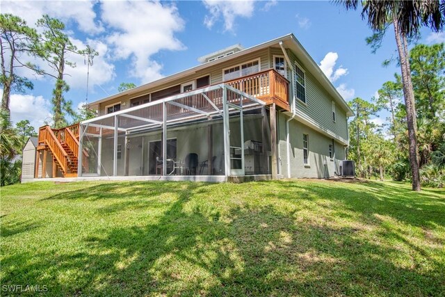 430 Shady Hollow Blvd E, Naples, FL 34120 - rear view of property with central air condition unit, a lawn, a sunroom, and a wooden deck
