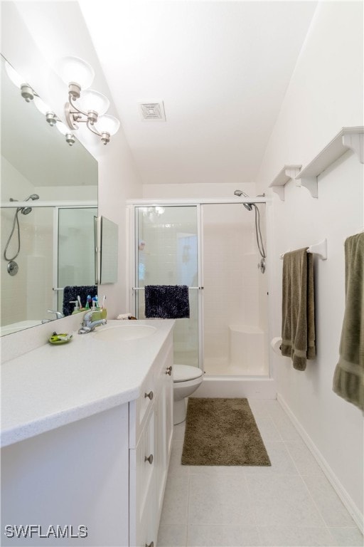 bathroom with walk in shower, tile patterned floors, vanity, and toilet