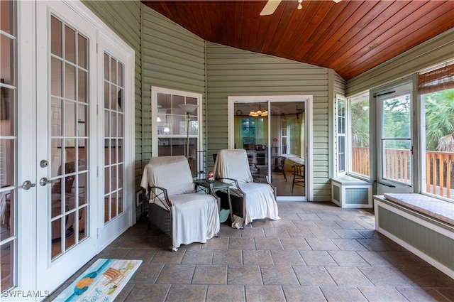 sunroom featuring vaulted ceiling, wooden ceiling, and ceiling fan