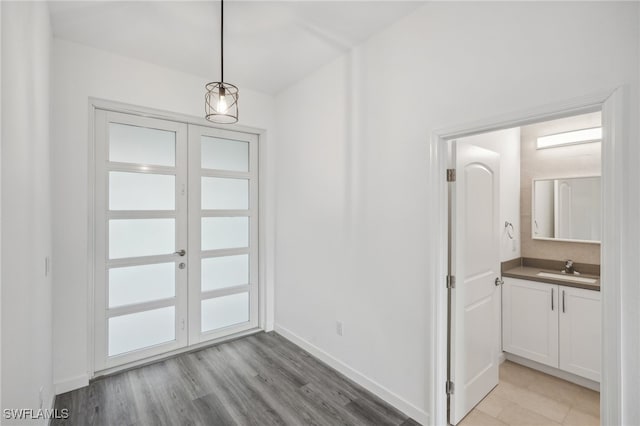 entrance foyer with light wood-type flooring and sink