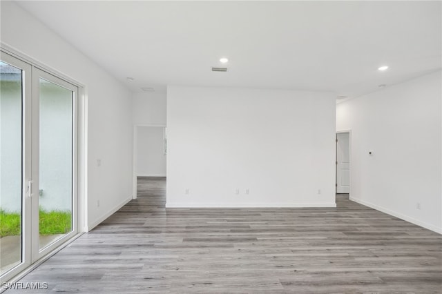 unfurnished room with light hardwood / wood-style floors and plenty of natural light