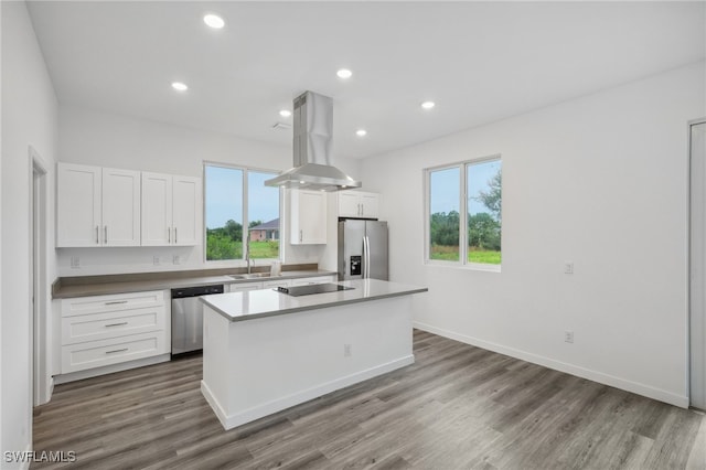 kitchen featuring white cabinets, dark hardwood / wood-style flooring, stainless steel appliances, and range hood