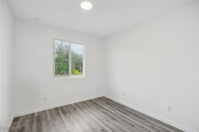 unfurnished room with light wood-type flooring