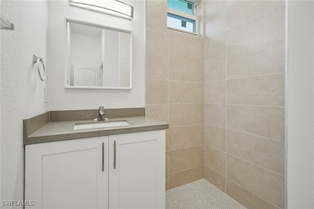 bathroom featuring vanity and tiled shower