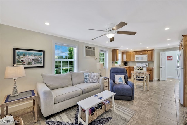 living room with crown molding, a wall unit AC, ceiling fan, and sink