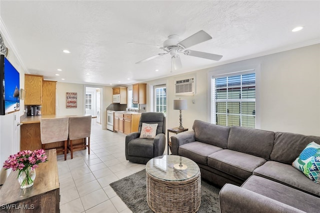 tiled living room featuring ceiling fan, a textured ceiling, and ornamental molding