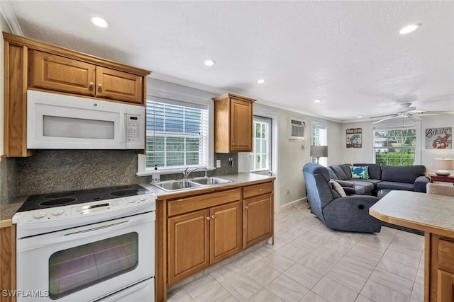 kitchen featuring crown molding, white appliances, and backsplash