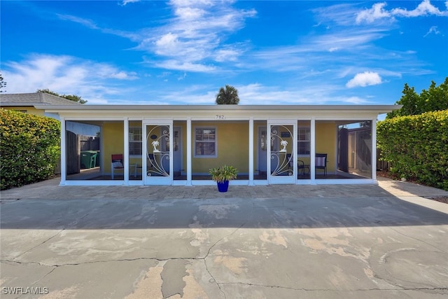 back of property with a porch and a carport