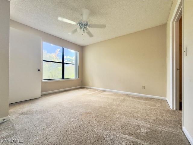 carpeted empty room with a textured ceiling and ceiling fan