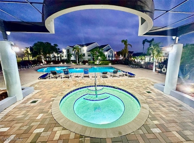 view of swimming pool featuring a patio area and a hot tub