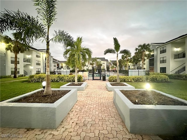 surrounding community with playground community, a residential view, fence, and a lawn