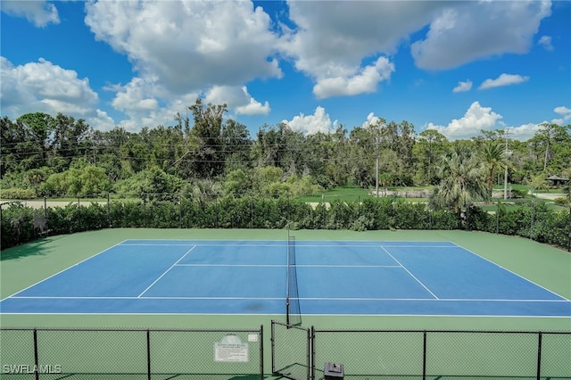 view of tennis court with fence