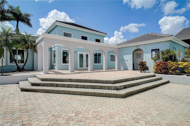 rear view of house featuring french doors and a patio