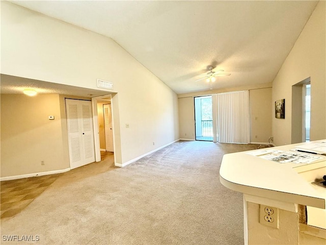 unfurnished living room with carpet, vaulted ceiling, and ceiling fan