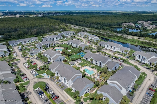 bird's eye view featuring a water view, a residential view, and a view of trees