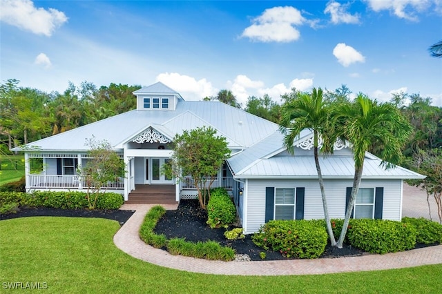 view of front of property featuring covered porch and a front lawn