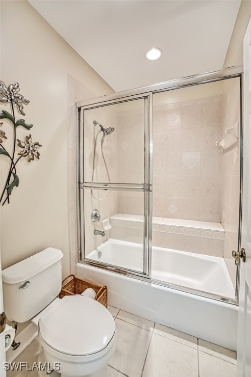 bathroom with toilet, combined bath / shower with glass door, and tile patterned floors