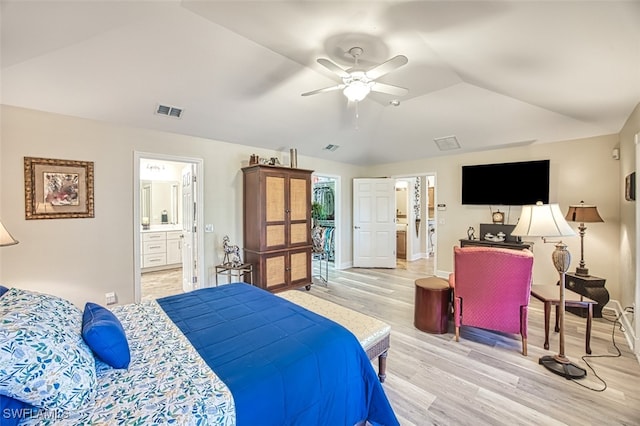 bedroom featuring light hardwood / wood-style flooring, vaulted ceiling, ceiling fan, and ensuite bathroom