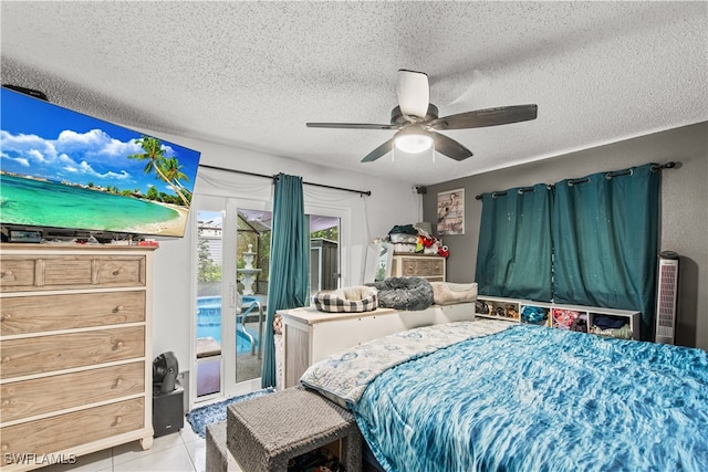 tiled bedroom with ceiling fan, access to exterior, and a textured ceiling