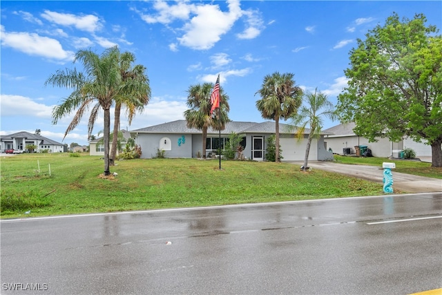 ranch-style house with a garage and a front lawn