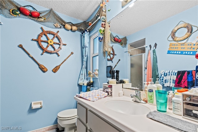 bathroom featuring an enclosed shower, vanity, a textured ceiling, and toilet