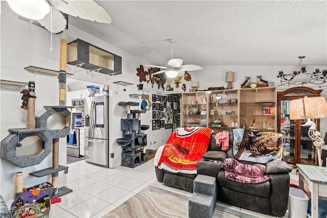 tiled living room featuring ceiling fan, a textured ceiling, and lofted ceiling