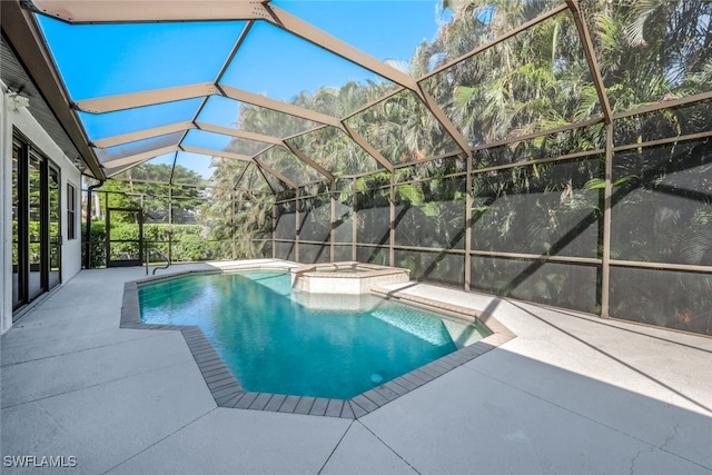 view of pool with an in ground hot tub, glass enclosure, and a patio area