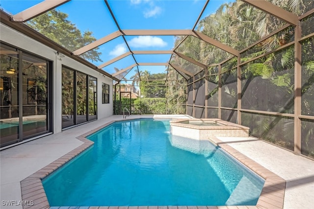 view of swimming pool featuring a jacuzzi, a lanai, and a patio area