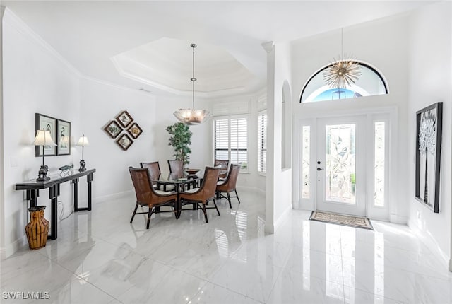 foyer featuring a raised ceiling and ornamental molding