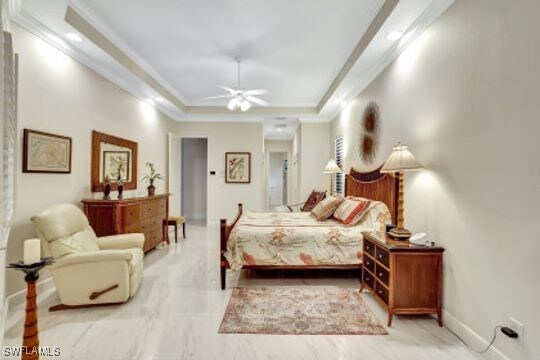 bedroom with a raised ceiling, ceiling fan, and crown molding