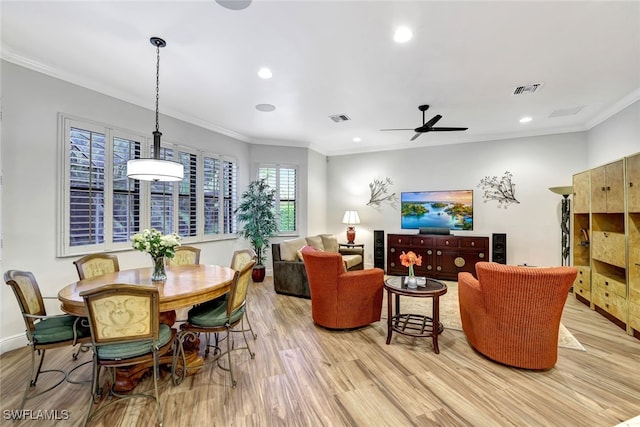 living room featuring light hardwood / wood-style floors, ceiling fan, and crown molding