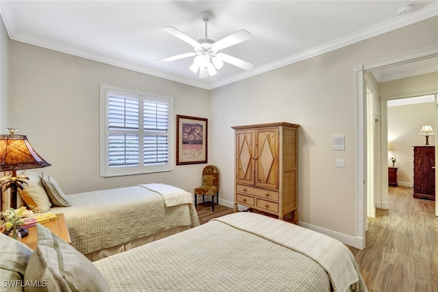 bedroom with ceiling fan, crown molding, and light wood-type flooring