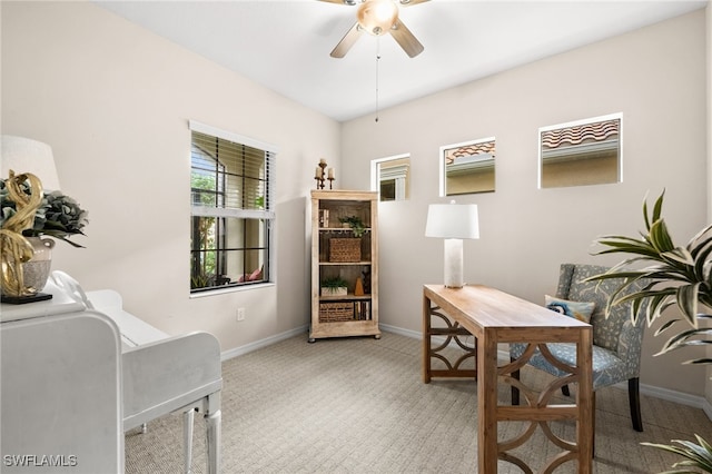 carpeted office featuring ceiling fan