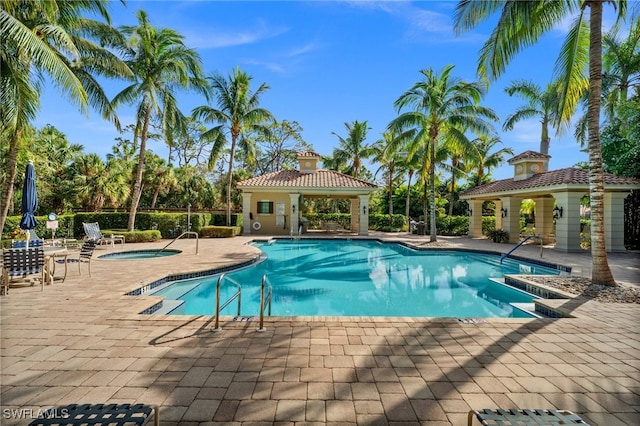 view of swimming pool featuring a patio and a gazebo