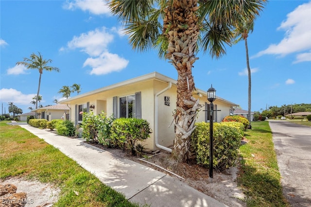 83 Glades Blvd Unit 2Apt 1612, Naples, FL 34112 - view of side of home featuring stucco siding