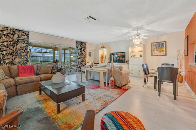 living room featuring light wood-type flooring and ceiling fan