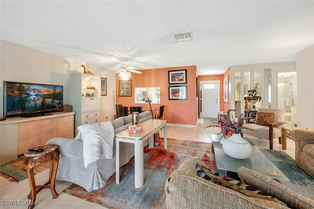 living room with light hardwood / wood-style flooring and ceiling fan