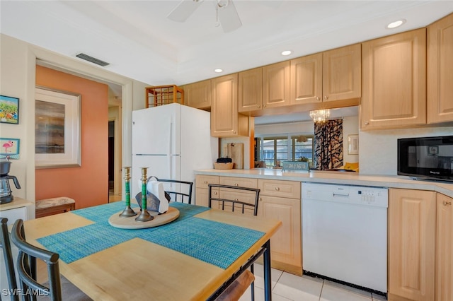 kitchen featuring ceiling fan with notable chandelier, light brown cabinetry, white appliances, and light tile patterned floors