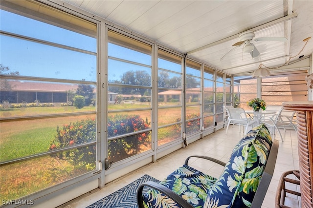 sunroom / solarium featuring ceiling fan and a healthy amount of sunlight