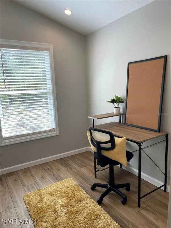 office featuring light hardwood / wood-style flooring and vaulted ceiling