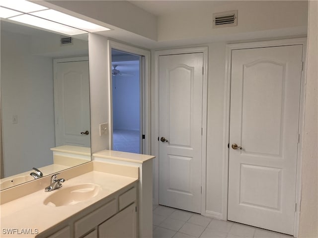 bathroom with tile patterned floors and vanity