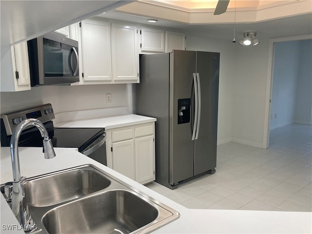 kitchen featuring white cabinets, light tile patterned floors, sink, and appliances with stainless steel finishes