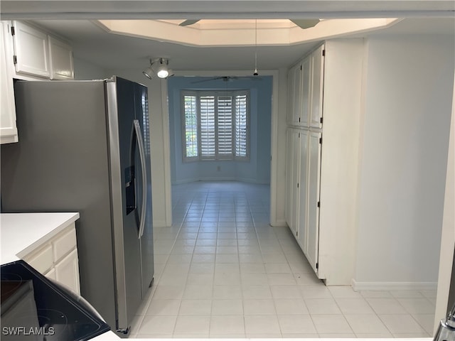 kitchen featuring white cabinets, ceiling fan, stainless steel fridge with ice dispenser, and light tile patterned floors