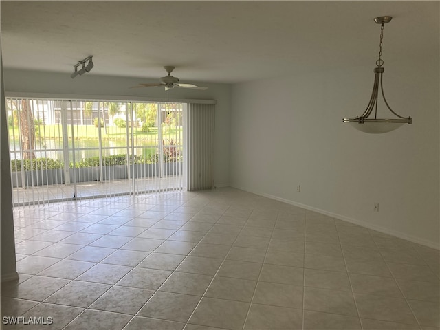 unfurnished room with ceiling fan and light tile patterned flooring