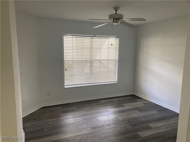 empty room featuring dark hardwood / wood-style flooring and ceiling fan